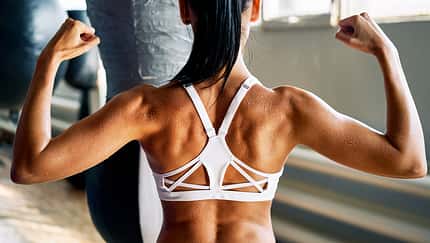 Close,Up,Of,Woman,Back,With,Flexing,Her,Muscles,In