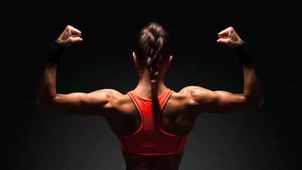 Athletic,Young,Woman,Showing,Muscles,Of,The,Back,And,Hands