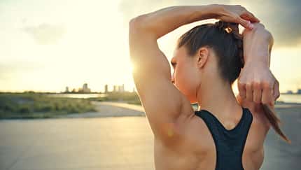Athletic,Woman,Warming,Up,Before,A,Workout,Standing,Facing,The