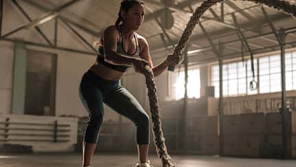 Young,Woman,Doing,Strength,Training,Using,Battle,Ropes,At,The