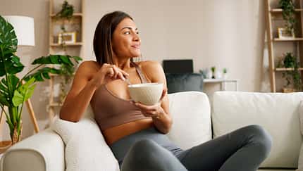 Beautiful,Young,Woman,Is,Sitting,On,The,Sofa,In,The