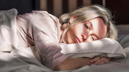 Stressed,Middle,Aged,Woman,Lying,On,Bed,At,Home,And