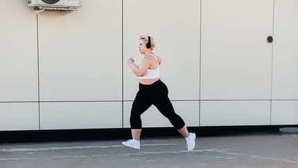 Side,View,Of,A,Woman,With,Plus,Size,Body,Running