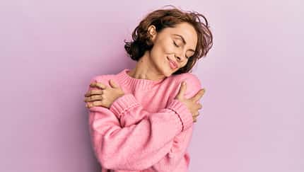 Young,Brunette,Woman,Wearing,Casual,Winter,Sweater,Hugging,Oneself,Happy