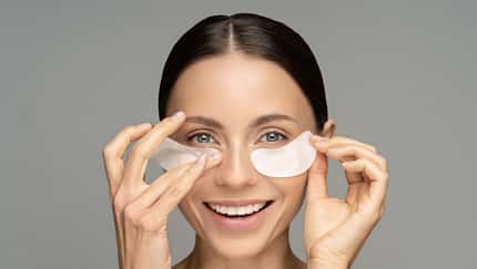 Happy,Woman,Applying,Hydrogel,Under-eye,Recovery,Patches,Enriched,With,Collagen,