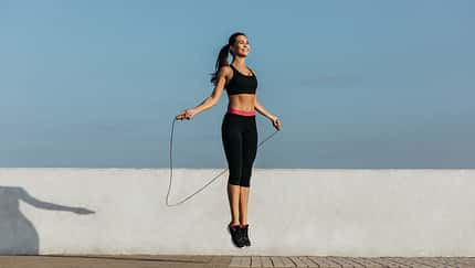 Young woman training with a jumping rope