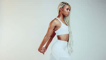 African,American,Fitness,Woman,Stretching,Her,Arms,During,Workout.,Fit