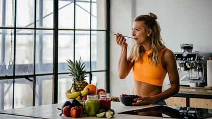 Eine Frau isst gesundes Obst und Gemüse