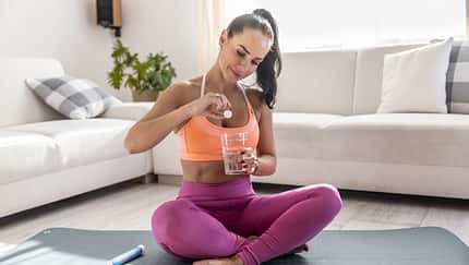 magnesia,sportswear Young woman i sportswear with magnesia effervescent tablet and glass of pure or mineral water.