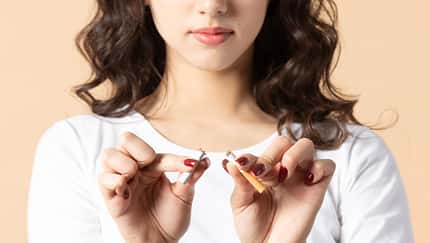 Woman breaking cigarette