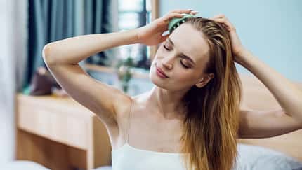 Head massage equipment on wooden surface. Massager for head and body relaxing. Stainless steel octopus scalp hair stress relief head massager. Headache and migraine. Home use Acupuncture Point.