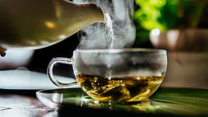 Fresh hot water for organic sage herbal tea at teatime.