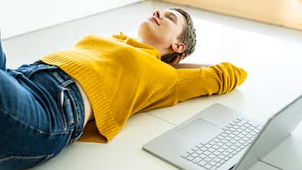 offline,ground,female caucasian,caucasian,pullover,adults,happy,casual,female,peace,mature adults,daydreaming,serenity,job,floor,mature woman,remote work,business people,40-50 years Woman relaxing on the floor with a laptop in a bright office space