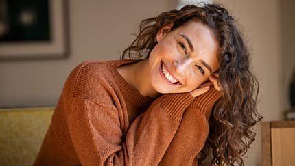Young woman laughing while relaxing at home