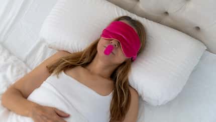Woman using mouth tape to promote nasal breathing. Woman using mouth tape to promote nasal breathing.