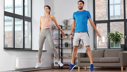 happy couple exercising at home
