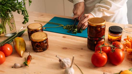 Woman chops parsley for preparing vegetables