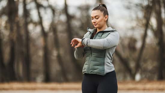 Woman Checking Fitness Tracker Outdoor Early Morning