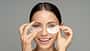 Happy,Woman,Applying,Hydrogel,Under-eye,Recovery,Patches,Enriched,With,Collagen,