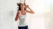 Happy,Young,Woman,In,Earphones,Is,Listening,To,Music,With