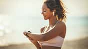 A,Beautiful,Young,Woman,Is,Looking,At,Smartwatch,And,Preparing