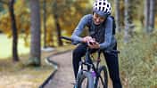 Young,Smiling,Woman,In,A,Tracksuit,On,A,Mountain,Bike