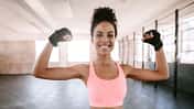 Portrait,Of,Young,Fitness,Woman,Flexing,Muscles,And,Smiling.,African
