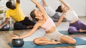 Motivated,Young,Girl,Performing,Mermaid,Stretch,With,Ball,In,Group