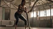 Young,Woman,Doing,Strength,Training,Using,Battle,Ropes,At,The