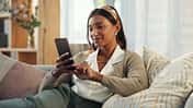 Cellphone,,Indian,Woman,And,Smile,On,Sofa,In,Home,In