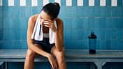 Tired,Fit,Woman,With,A,Towel,In,The,Locker,Room