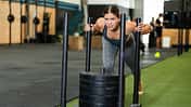 Young,Athletic,Woman,In,Sportswear,Training,On,Sled,In,Gym