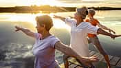 Group,Of,Senior,Woman,Doing,Yoga,Exercises,By,The,Lake.