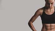Portrait,Of,Sporty,Young,Woman,With,Muscular,Body,,Posing,Against