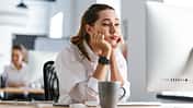 Bored,Young,Woman,Dressed,In,Shirt,Sitting,At,Her,Workplace