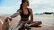 Athlete,Doing,Stretching,Exercises,On,Running,Track.,Woman,Runner,Stretching
