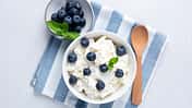 Cottage,Cheese,,Quark,Or,Curd,In,Bowl,Served,With,Blueberries