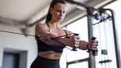 Fit,Young,Woman,Doing,Cable,Pec,Fly,Exercise,In,Gym,