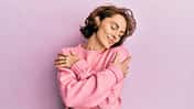 Young,Brunette,Woman,Wearing,Casual,Winter,Sweater,Hugging,Oneself,Happy