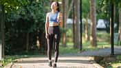 Young,Asian,Woman,,Dressed,In,Sportswear,,Walks,Along,A,Park