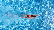 Active,Girl,In,Swimming,Pool,Aerial,Drone,View,From,Above,