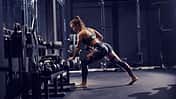 Strong,Muscular,Caucasian,Woman,In,Sportswear,And,With,Pigtail,Lifting