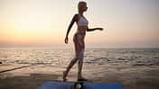 Young,Slim,Blonde,Woman,With,Tattoos,Standing,On,Wooden,Desk