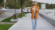 Full,Body,Young,Woman,Wear,Orange,Shirt,Casual,Clothes,Listen