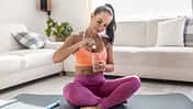 Young woman i sportswear with magnesia effervescent tablet and glass of pure or mineral water.