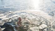 Happy Woman Treading Water With Ice In The Ocean In Denmark