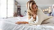 Laughing woman covering her eyes with her hair