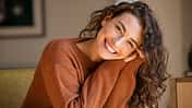 Young woman laughing while relaxing at home